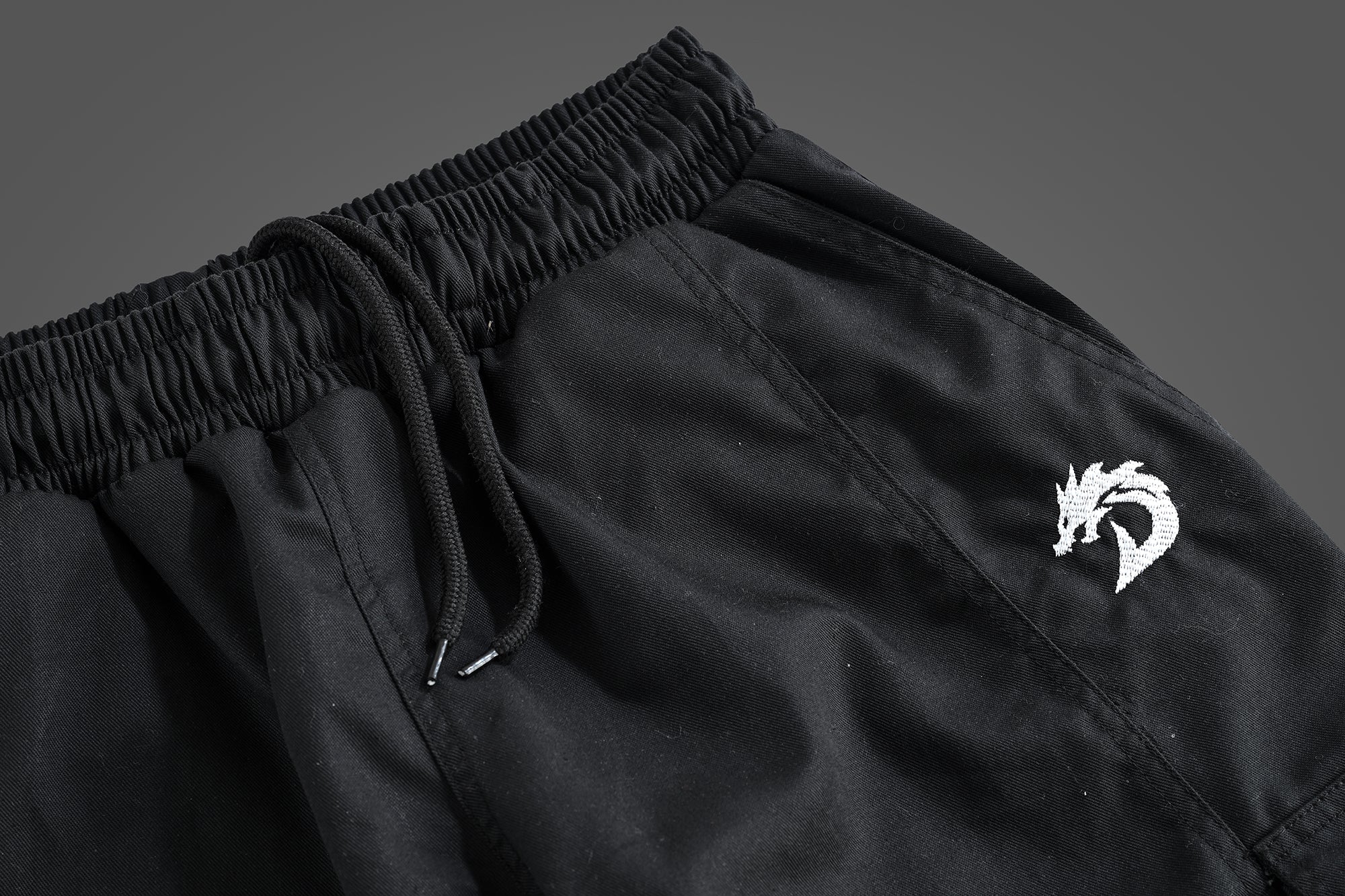 Black cargo pants for outdoor activities, durable and versatile men's pants with multiple pockets, ideal for hiking, camping, trekking, and adventure wear